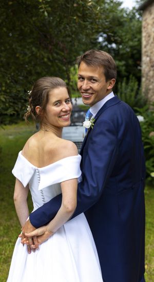 couple de mariés dans un jardin robe de mariee sur mesure par be vernier